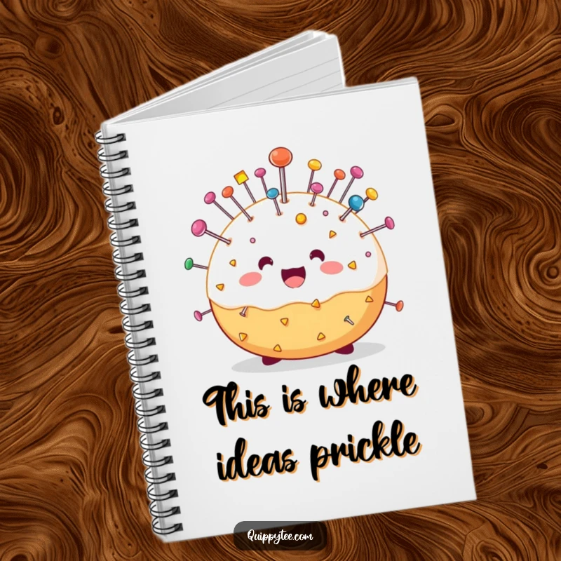 Funny notebook with a happy pin cushion character bristling with colorful pins, ideal for jotting down creative ideas and sewing plans humorously.