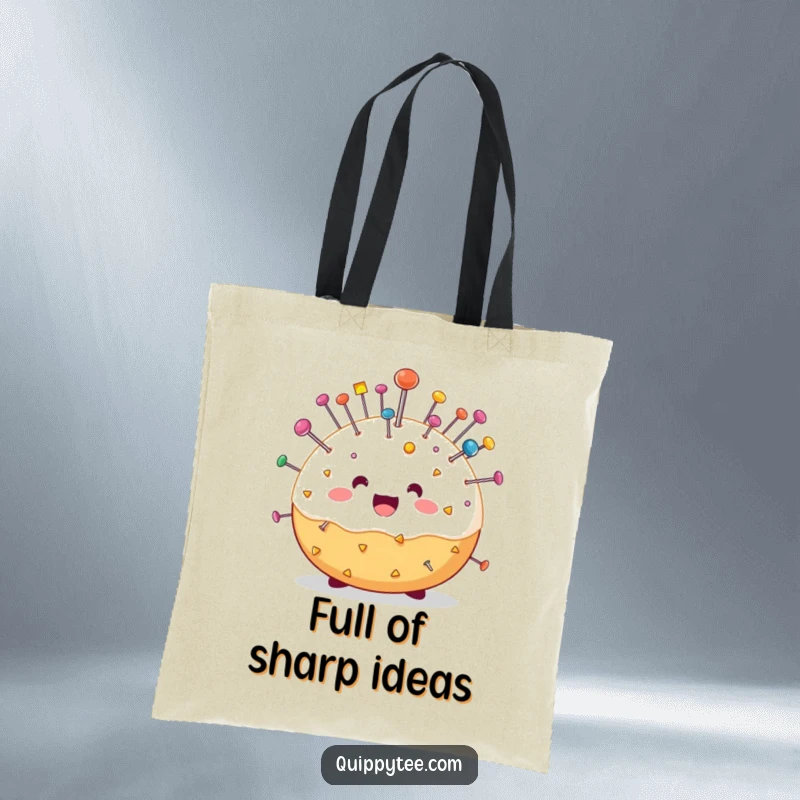 Funny tote bag featuring a cheerful pin cushion character bristling with colorful pins, perfect for carrying supplies with a humorous flair.